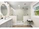 Bright bathroom featuring a walk-in shower with glass enclosure and gray vanity at 1927 Alexander Se St, Smyrna, GA 30080