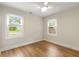 Bright, empty bedroom featuring hardwood floors and two windows for natural light at 1927 Alexander Se St, Smyrna, GA 30080