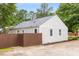 Side view of home with gray siding, dark roof, and partial brown fence at 1927 Alexander Se St, Smyrna, GA 30080