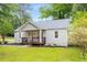 Traditional home featuring a cozy front porch and landscaped lawn at 1927 Alexander Se St, Smyrna, GA 30080