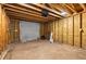 Inside the garage, showing the unfinished framing and a roll up door at 1927 Alexander Se St, Smyrna, GA 30080