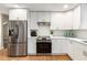 Bright kitchen featuring stainless steel appliances, white cabinets and wood flooring at 1927 Alexander Se St, Smyrna, GA 30080