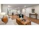 Spacious living room with modern decor, hardwood flooring, and a smooth transition to the kitchen and dining area at 1927 Alexander Se St, Smyrna, GA 30080
