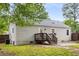 View of a charming home's rear exterior with a deck and a well-maintained lawn at 1927 Alexander Se St, Smyrna, GA 30080