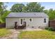 A pleasant view of the home's rear exterior featuring a small deck and fenced in yard at 1927 Alexander Se St, Smyrna, GA 30080