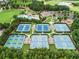 Aerial view of multiple tennis courts, pool, and club house at 3250 Seven Oaks Dr, Cumming, GA 30041