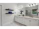 Bathroom boasts double sinks, granite countertops, and ample storage in custom white cabinetry at 3250 Seven Oaks Dr, Cumming, GA 30041