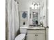 Compact bathroom featuring granite counters, vanity, toilet, and shower, designed for efficiency at 3250 Seven Oaks Dr, Cumming, GA 30041
