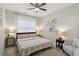 This light-filled bedroom features soft carpet, two windows and is well-lit with bedside lamps at 3250 Seven Oaks Dr, Cumming, GA 30041