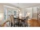 Bright dining room featuring a stylish table, wainscoting, bay window, and lovely decor at 3250 Seven Oaks Dr, Cumming, GA 30041