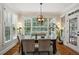 Light-filled dining room with a modern chandelier, large windows and beautiful views at 3250 Seven Oaks Dr, Cumming, GA 30041