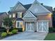 Elegant brick home with a two-car garage, well-kept lawn, and charming curb appeal at 3250 Seven Oaks Dr, Cumming, GA 30041