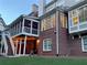 Brick home with a large screened porch with string lights, and a lush green lawn at 3250 Seven Oaks Dr, Cumming, GA 30041