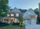 Stately brick home with manicured landscaping, two-car garage, and welcoming front porch at 3250 Seven Oaks Dr, Cumming, GA 30041