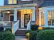 Charming brick home featuring a welcoming front door and a cozy porch with white pillars at 3250 Seven Oaks Dr, Cumming, GA 30041