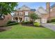 Beautiful brick home boasts an inviting front porch, manicured lawn, and attached two-car garage at 3250 Seven Oaks Dr, Cumming, GA 30041
