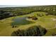 Scenic aerial of the meticulously maintained golf course with a serene pond and lush landscaping at 3250 Seven Oaks Dr, Cumming, GA 30041