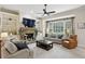Cozy living room with built-in bookshelves, stone fireplace, large windows, and neutral decor at 3250 Seven Oaks Dr, Cumming, GA 30041