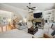 Comfortable living room featuring a stone fireplace, built-in bookshelves, and a staircase at 3250 Seven Oaks Dr, Cumming, GA 30041
