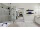 Modern bathroom with glass-enclosed shower, soaking tub, and neutral tile for a spa-like experience at 3250 Seven Oaks Dr, Cumming, GA 30041