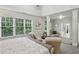 Bright main bedroom with large windows, a sitting area, and an en-suite bathroom with walk-in closet at 3250 Seven Oaks Dr, Cumming, GA 30041