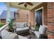 Relaxing covered porch with comfortable seating, a ceiling fan, and brick walls for a private atmosphere at 3250 Seven Oaks Dr, Cumming, GA 30041
