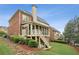 Exterior view of the rear of the home, including a screened porch and stone pathway at 3250 Seven Oaks Dr, Cumming, GA 30041