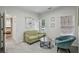 This cozy sitting room has two large windows, comfortable seating, and soft carpet at 3250 Seven Oaks Dr, Cumming, GA 30041