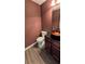 Stylish powder room featuring a vessel sink, modern faucet, and rich wall color at 4160 Post Oak Grv, Atlanta, GA 30349