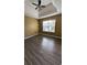 Bedroom with tray ceiling, fan, window and hardwood floors at 4160 Post Oak Grv, Atlanta, GA 30349