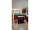 Well-appointed kitchen with an island, dark wood cabinetry, and stainless steel appliances at 4160 Post Oak Grv, Atlanta, GA 30349