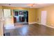 Open-concept living room with hardwood floors, adjacent kitchen, and recessed lighting at 4160 Post Oak Grv, Atlanta, GA 30349