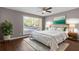 Comfortable bedroom features hardwood floors, ceiling fan, and large sunny window at 5400 Roswell Rd # Apt E6, Sandy Springs, GA 30342