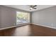 Bedroom features hardwood floors, ceiling fan, and a large window at 5400 Roswell Rd # Apt E6, Sandy Springs, GA 30342