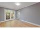 Minimalist dining room with hardwood floors, gray walls, and large French doors, creating a bright and airy space at 5400 Roswell Rd # Apt E6, Sandy Springs, GA 30342