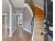Inviting entryway featuring hardwood floors, curved staircase, and a view into the adjacent kitchen at 5400 Roswell Rd # Apt E6, Sandy Springs, GA 30342