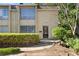 Charming townhome featuring a classic brick facade, manicured shrubs, and large windows providing ample natural light at 5400 Roswell Rd # Apt E6, Sandy Springs, GA 30342