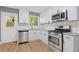Bright kitchen featuring stainless steel appliances, granite countertops, and white cabinetry at 5400 Roswell Rd # Apt E6, Sandy Springs, GA 30342