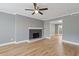 Spacious living room features a modern fireplace, neutral wall color, and gleaming hardwood floors at 5400 Roswell Rd # Apt E6, Sandy Springs, GA 30342