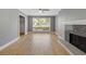 Bright living room featuring hardwood floors, a large window, and a stylish fireplace at 5400 Roswell Rd # Apt E6, Sandy Springs, GA 30342