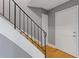 Staircase with modern black railing, neutral wall color, and adjacent door, offering a clean and functional design at 5400 Roswell Rd # Apt E6, Sandy Springs, GA 30342