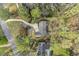 Expansive aerial view of the home showcasing a curved driveway, meticulous landscaping, and lush greenery at 7265 Hunters Branch Dr, Sandy Springs, GA 30328