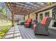 Relax on the back porch under a pergola with outdoor seating and a hot tub at 7265 Hunters Branch Dr, Sandy Springs, GA 30328