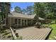 A perfect space to enjoy outdoor living featuring a large deck and lush backyard, with a pergola covered seating area at 7265 Hunters Branch Dr, Sandy Springs, GA 30328