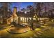 A cozy outdoor space with a wooden deck, hanging chairs, and a view of the landscaped yard at 7265 Hunters Branch Dr, Sandy Springs, GA 30328