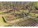 Expansive backyard with tiered landscaping, a waterfall feature, and a wooded backdrop at 7265 Hunters Branch Dr, Sandy Springs, GA 30328