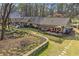 Spacious backyard with a stone retaining wall, a hot tub, and ample space for outdoor entertaining at 7265 Hunters Branch Dr, Sandy Springs, GA 30328