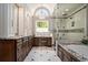 A spacious bathroom features double vanities, a makeup counter, a jacuzzi tub, and a glass enclosed shower at 7265 Hunters Branch Dr, Sandy Springs, GA 30328