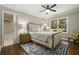 Cozy bedroom featuring hardwood floors, a ceiling fan, neutral colors, and lots of natural light at 7265 Hunters Branch Dr, Sandy Springs, GA 30328