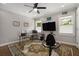 A bonus room featuring a ceiling fan, desk, workout bike, and natural light at 7265 Hunters Branch Dr, Sandy Springs, GA 30328